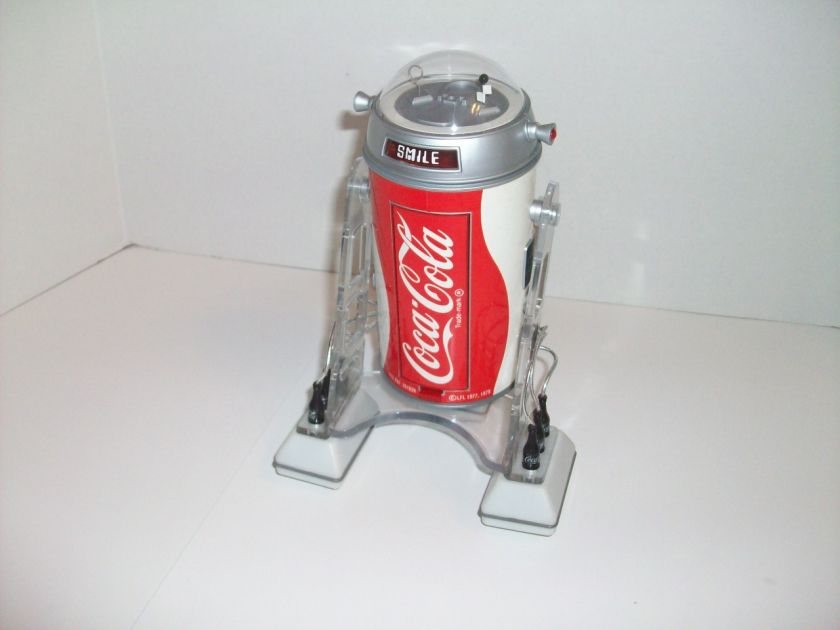 1977 COCA COLA COBOT IS PLASTIC,WITH REMOTE CONTROL,MEASURES 9 TALL 